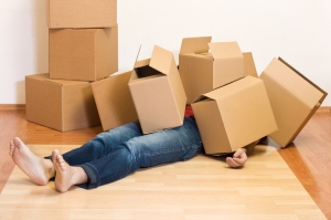 Man covered by lots of cardboard boxes - moving concept